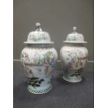 A pair of large Chinese baluster vases, the lids with dog of Fo finial, 60cm high