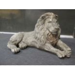 A reconstituted stone recumbent lion, 34 x 63cm