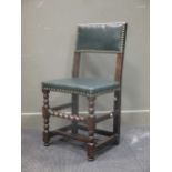 A 17th century Cromwellian oak single chair, the rectangular back and seat upholstered in dark green