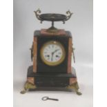 A late 19th century black marble mantel clock, drum movement, circular white enamel dial with