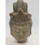 An early 19th century carved wood and polychrome decorated head of Buddha, 40cm high