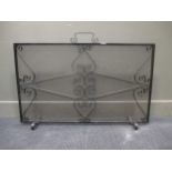 A wrought iron and mesh spark guard 63cm high and 102cm wide