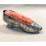 A German metalwares novelty pin cushion in the form of a shoe, indistinctly marked with the crescent