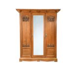 An Arts & Crafts oak triple wardrobe, circa 1900,