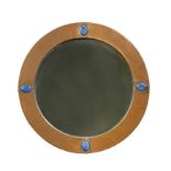 An Arts & Crafts copper framed circular wall mirror,