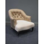 A late Victorian ebonised button back armchair with loose cover, stamped to the rear leg 0934