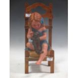 An early 20th century figure, girl on chair with dog , entitled Fais le beau by A de Ranieri, with