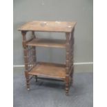Leonard Wyburd for Liberty's, a three tiered oak book stand on turned supports and castors, 83 x