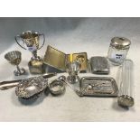A collection of silverware including pin trays, egg cups, napkin ring, flatware, dressing table
