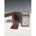A brass carriage clock with original travelling case and key