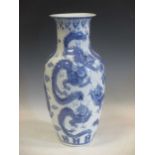 A large Chinese blue and white vase with dragons in raised relief, made in China to base