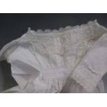 A box of Victorian and Edwardian cotton or linen robes and clothes, including a fine blouse with
