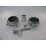 Two Georgian silver cauldron salts with spoons together with a silver matchbox sleeve by Liberty &