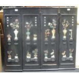 Four black lacquer panels inlaid with semi precious stones, the inlay depicting vases of flowers and