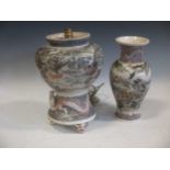 Two Japanese Meiji period satsuma vases decorated with elaborate battle scenes and dragons, signed