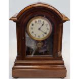 Eureka electric mantel clock, mahogany arch top case with pillars to the sides, visible movement,