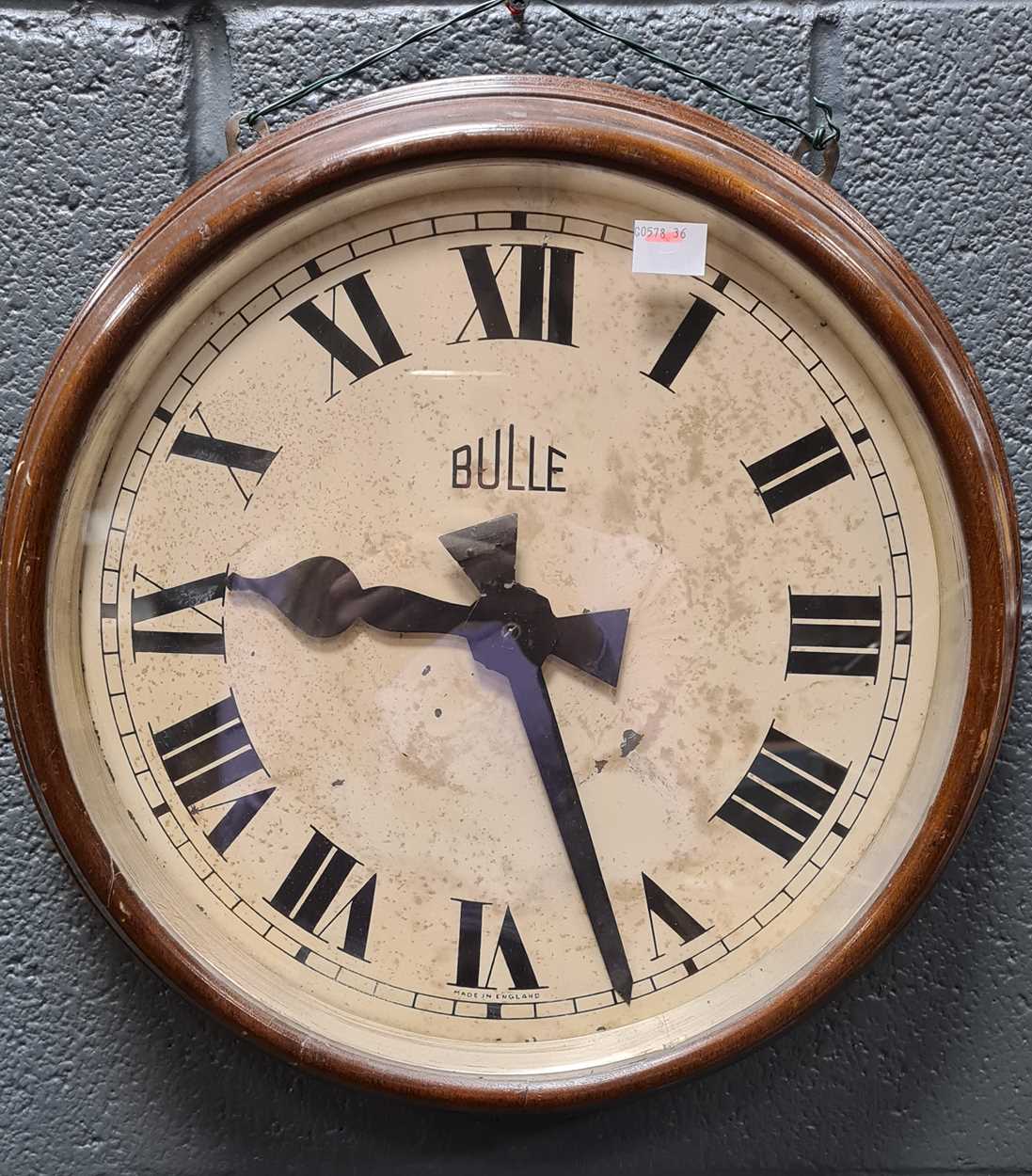 Circular Bulle mahogany case wall clock with stained dial and a smaller Bulle clock with silvered