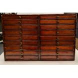 A bank of 18 clock or watch maker's drawers, c.1900, in stained pine case