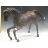 Folk Art - A Leather covered wood carved horse sculpture, 62cm high
