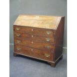 An early 19th century mahogany fall fronted bureau enclosing a fitted interior, over four