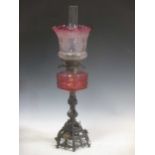 A Victorian cranberry glass etched oil lamp, total height 70cm