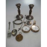 A pair of silver dwarf candlesticks together with two gold plated open faced pocket watches, two WW1