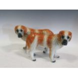 A pair of antique Staffordshire St Bernard dog figures with glass eyes 33cm long by 23cm tall