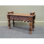 A late Victorian carved oak stool with turned scroll handles 50 x 77 x 46cm