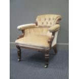 An early Victorian walnut button back armchair on brass castors, rear leg stamped "John Taylor &