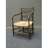 A Regency faux bamboo ebonised elbow chair