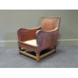A 20th century leather studded deep armchair (Lacking set cushion)
