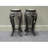 A pair of Chinese hardwood urn stands with marble inserts, 61 x 26cm diam