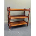 A 19th century mahogany three tier buffet/ serving trolly with fluted finials and brass cup with