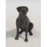 A bronze model of a seated dog 14.5cm high