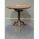 A George III style carved tripod table, with shaped border, on bird cage support, 75cm diam