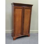 An early Victorian mahogany two door bookcase with key and height adjustable shelves on bracket