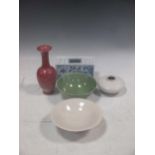 A modern Chinese celadaon bowl, a sang de boeuf vase, a modern Chinese white glazed bowl and a vase;