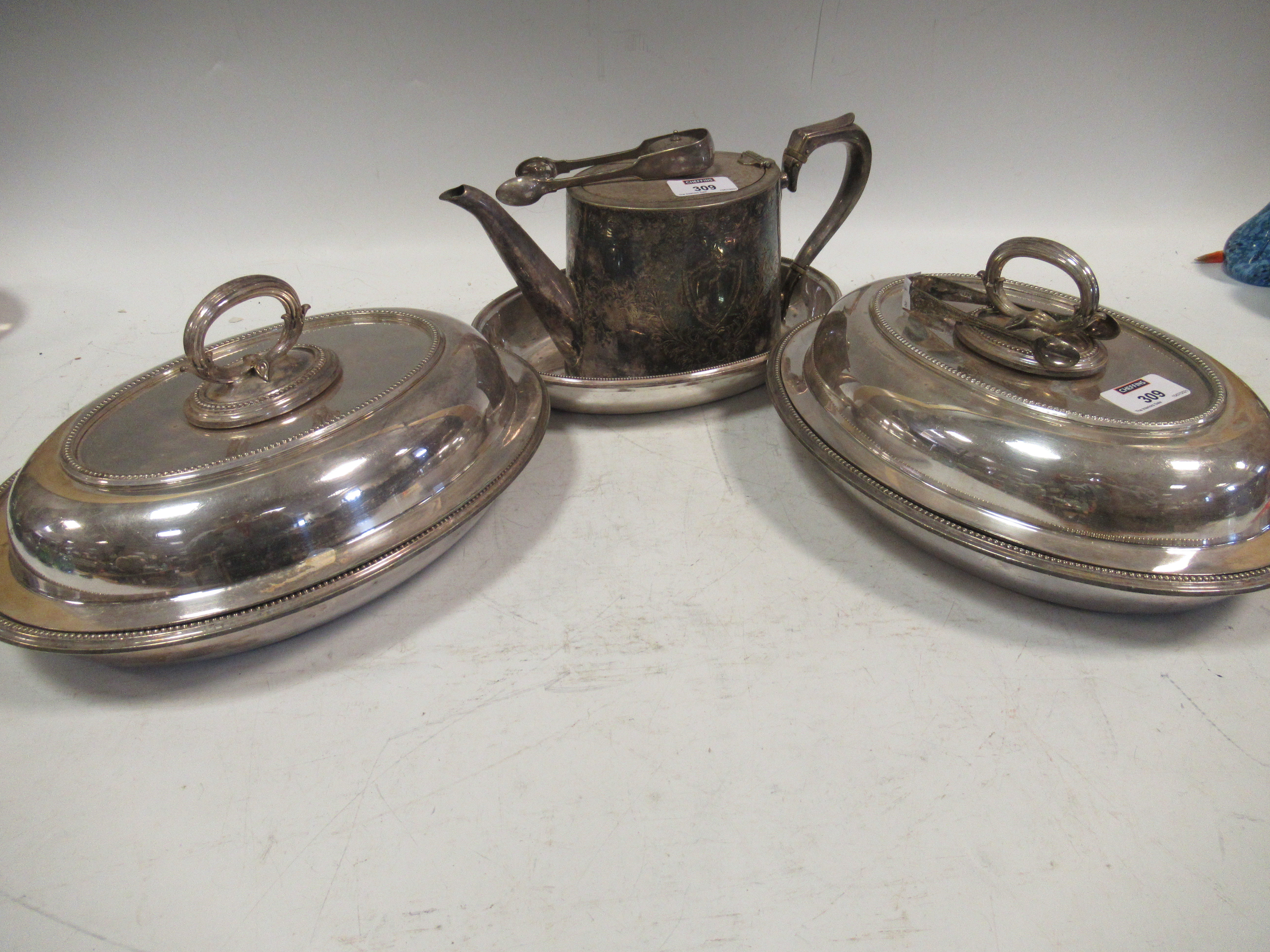 A collection of electroplated wares, including a pair of entrée dishes, a tea pot, tongs etc.