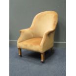 A late victorian easy armchair with banded legs on castors.