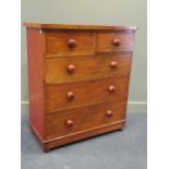 A 19th century mahogany chest of two short over three long graduating drawers with turned bun