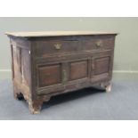 An 18th century oak cupboard with two drawers over two panelled doors on bracket feet, 80 x 131 x