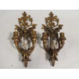 A pair of Neoclassical style gilt sconces with cherubs playing trumpets, modern, 50cm high (2)