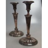 A pair of silver plated copper candlesticks