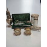 A silver sugar caster and two napkin rings together with a cased manicure set and three silver