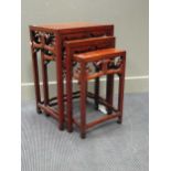 A Chinese nest of three burrwood tables, (probably elm), 66 x 46 x 34cm the largest