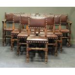 A set of twelve leather upholstered oak dining chairs