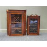 An early 19th century oak corner cupboard together with an Edwardian mahogany corner cupboard, 108 x