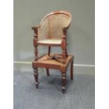 A 19th century mahogany child's bergere high chair on stand