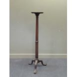 A mahogany torchere with pie crust top over a cluster column support with claw and ball feet,