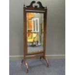 A 19th / early 20th century mahogany cheval mirror, with broken swan neck pediment and a rectangular